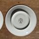 Pair of white porcelain cups from ADP France with a floral pattern and their s