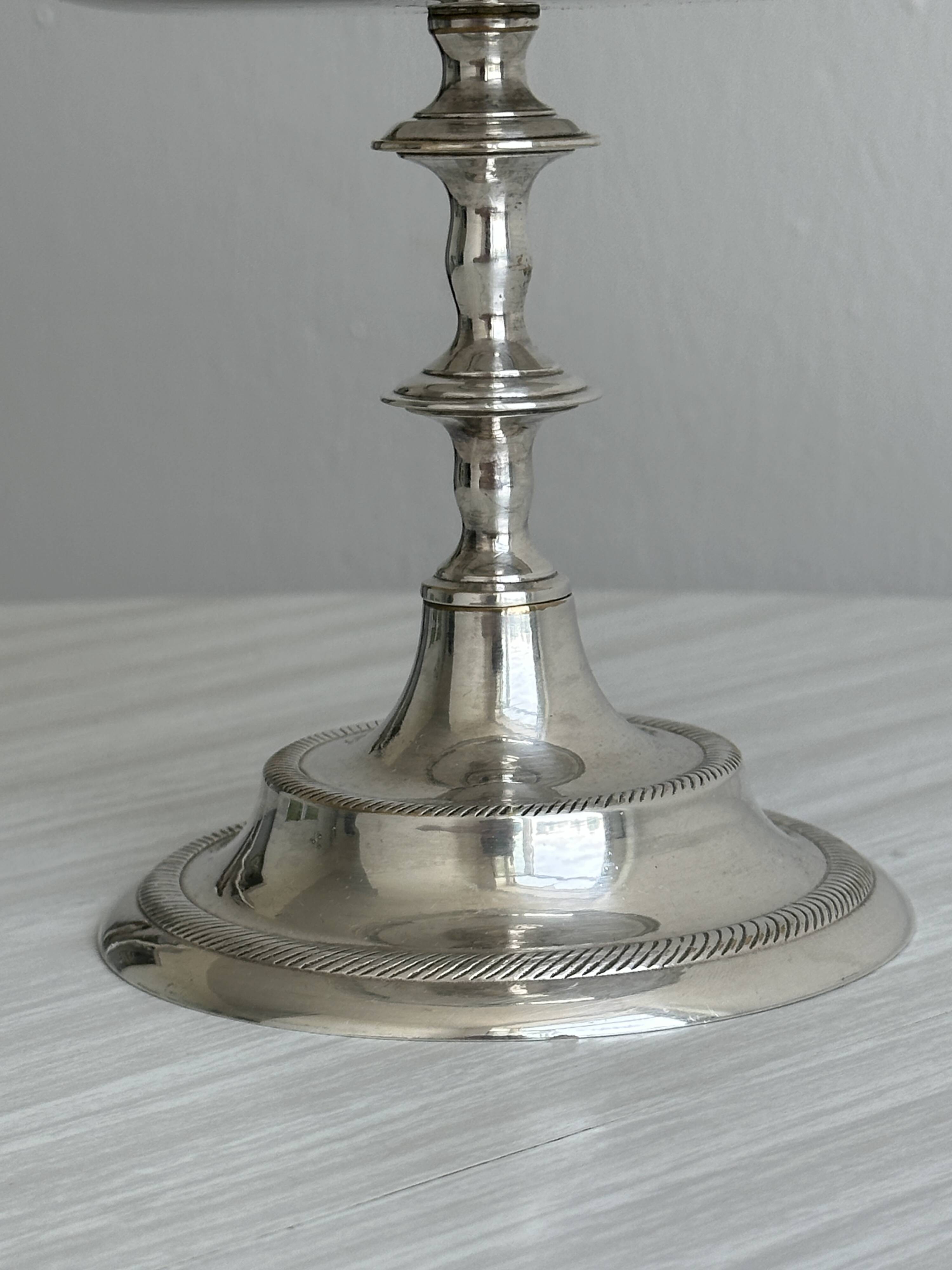 Silver-plated metal stand.
