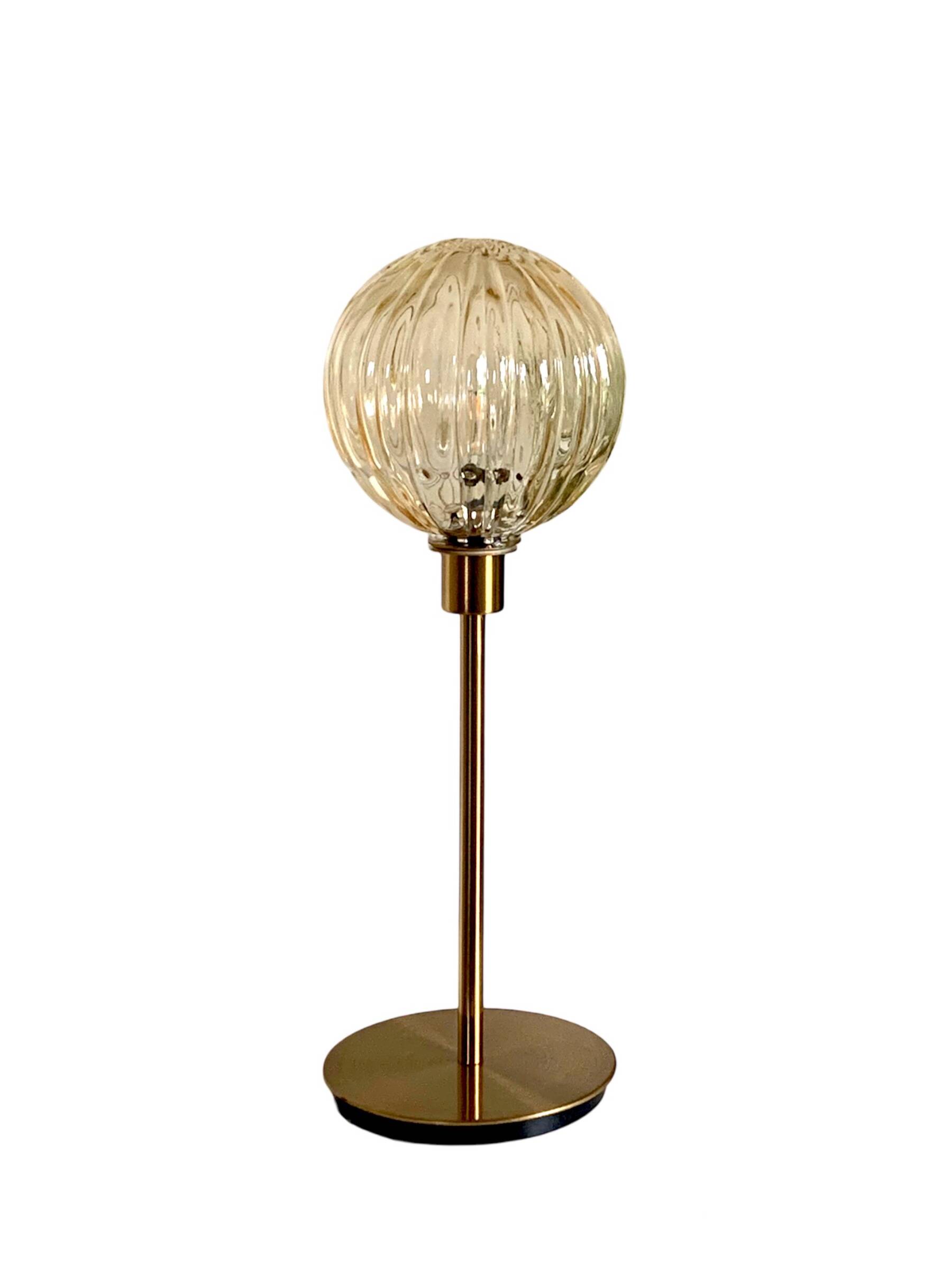 Table lamp with a golden striated globe and a golden base