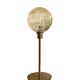 Table lamp with a golden striated globe and a golden base