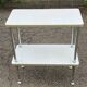 White and gold serving trolley in steel and wood