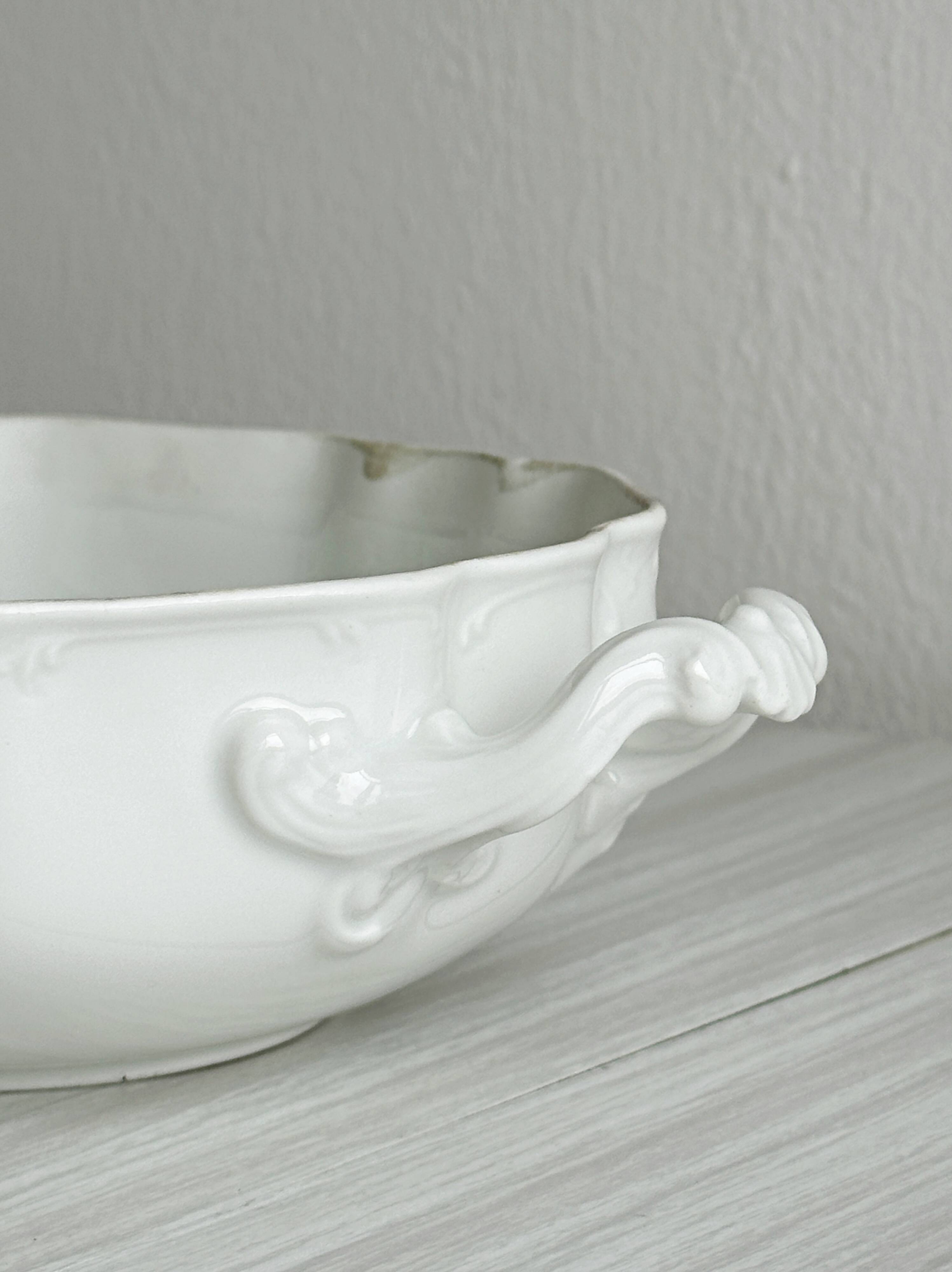 White fine porcelain soup tureen with relief decoration.