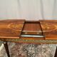 Louis XVI style oval dining table with rosewood marquetry extension mounted in bronze