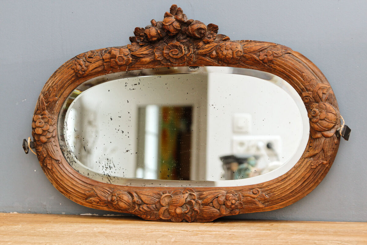 Beveled mirror in carved wood