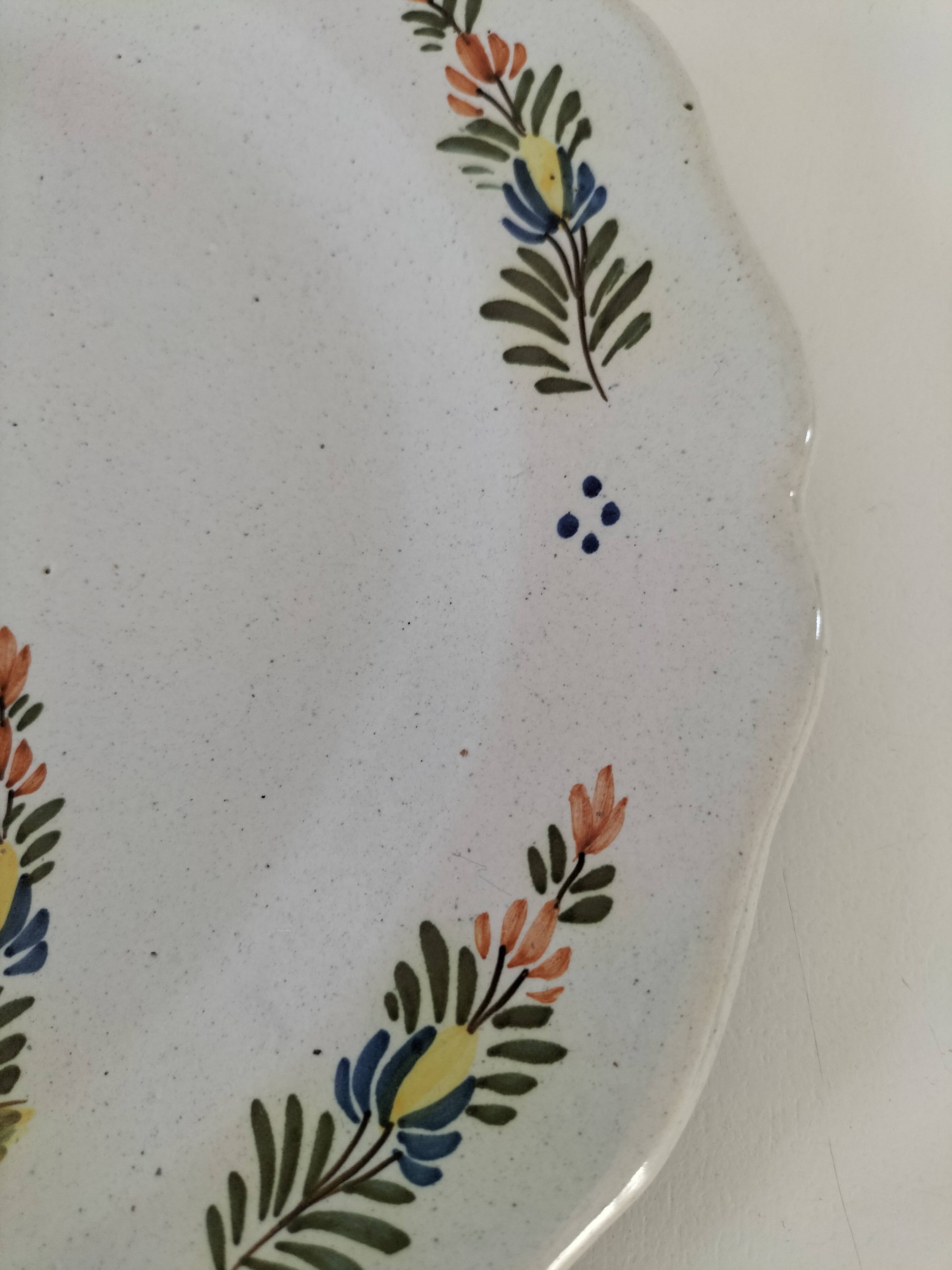 Hand-painted Breton plate, decorated with a woman knitting, 1950s