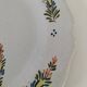 Hand-painted Breton plate, decorated with a woman knitting, 1950s