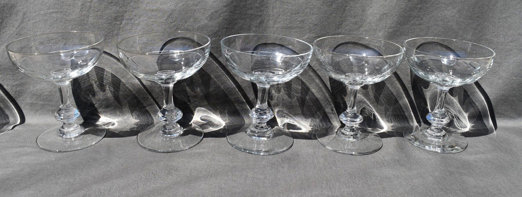9 old champagne glasses in flat-waisted blown glass