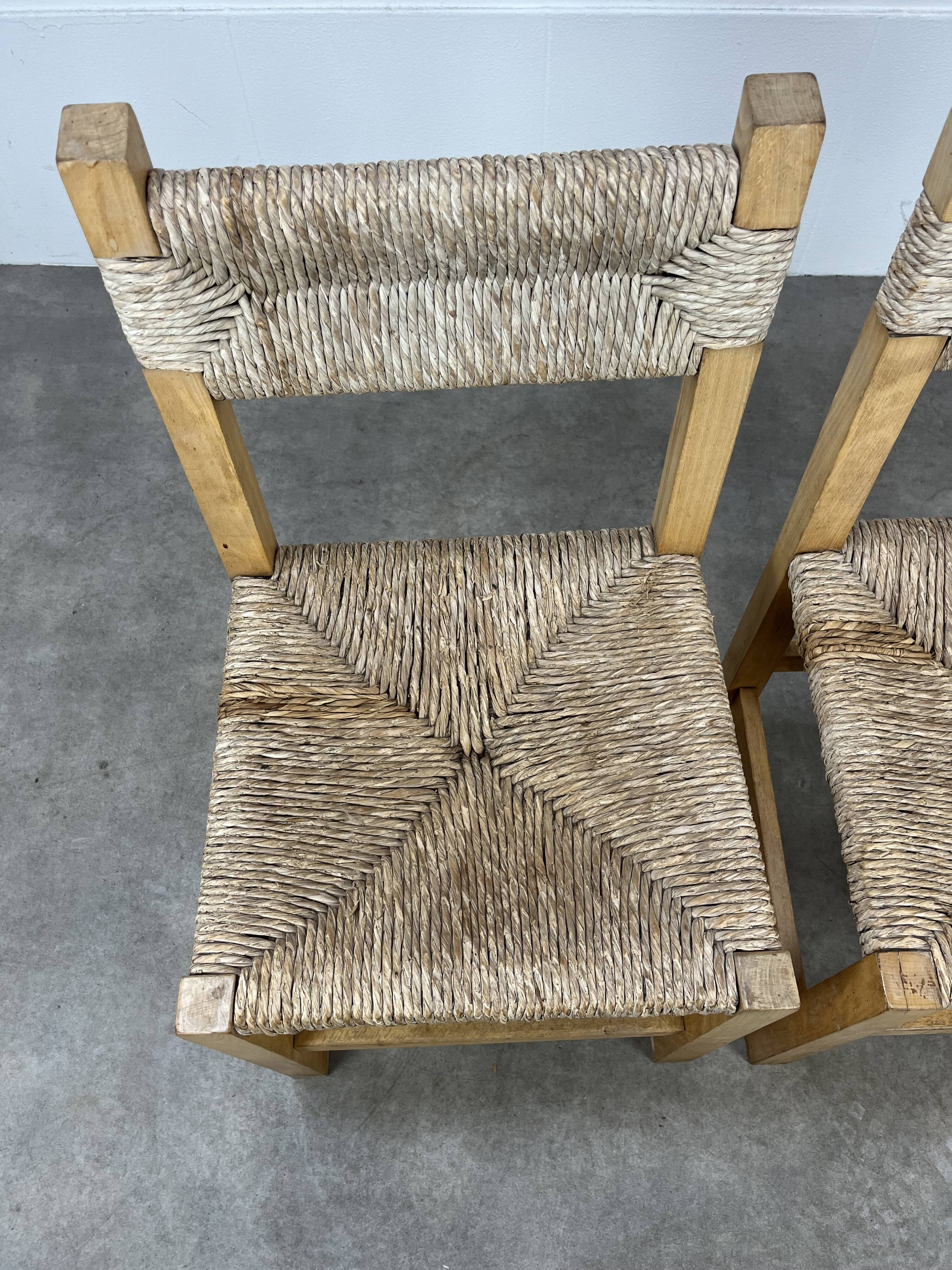 2 straw and wood chairs in brutalist style