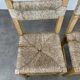 2 straw and wood chairs in brutalist style