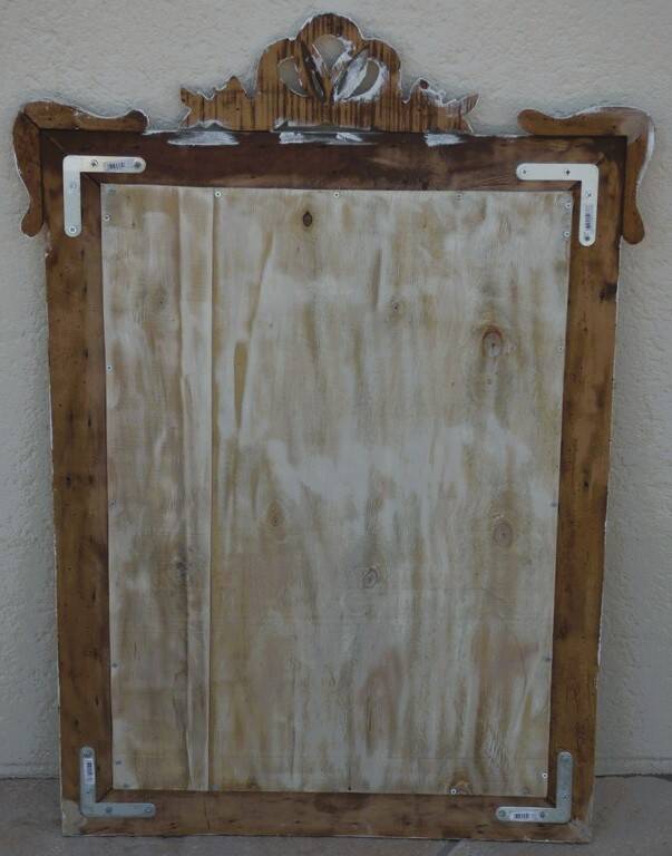 Chic and stylish antique mirror with carved wooden frame in whitewashed