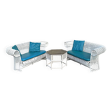Rattan lounge with two two-seater sofas and a white coffee table.