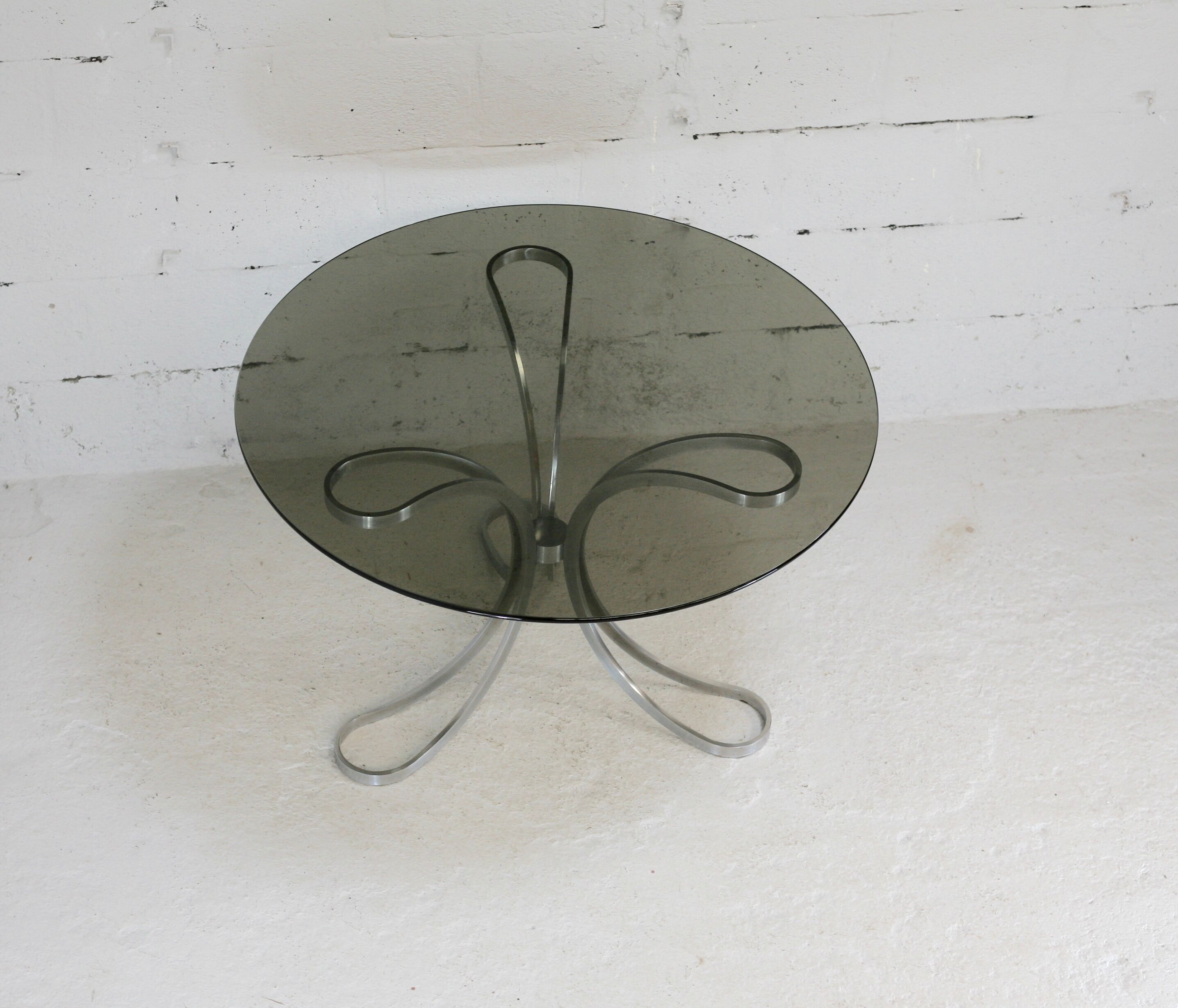 Living room table "Space Age" polished steel, circular slab smoked glass. France, circa 1970.