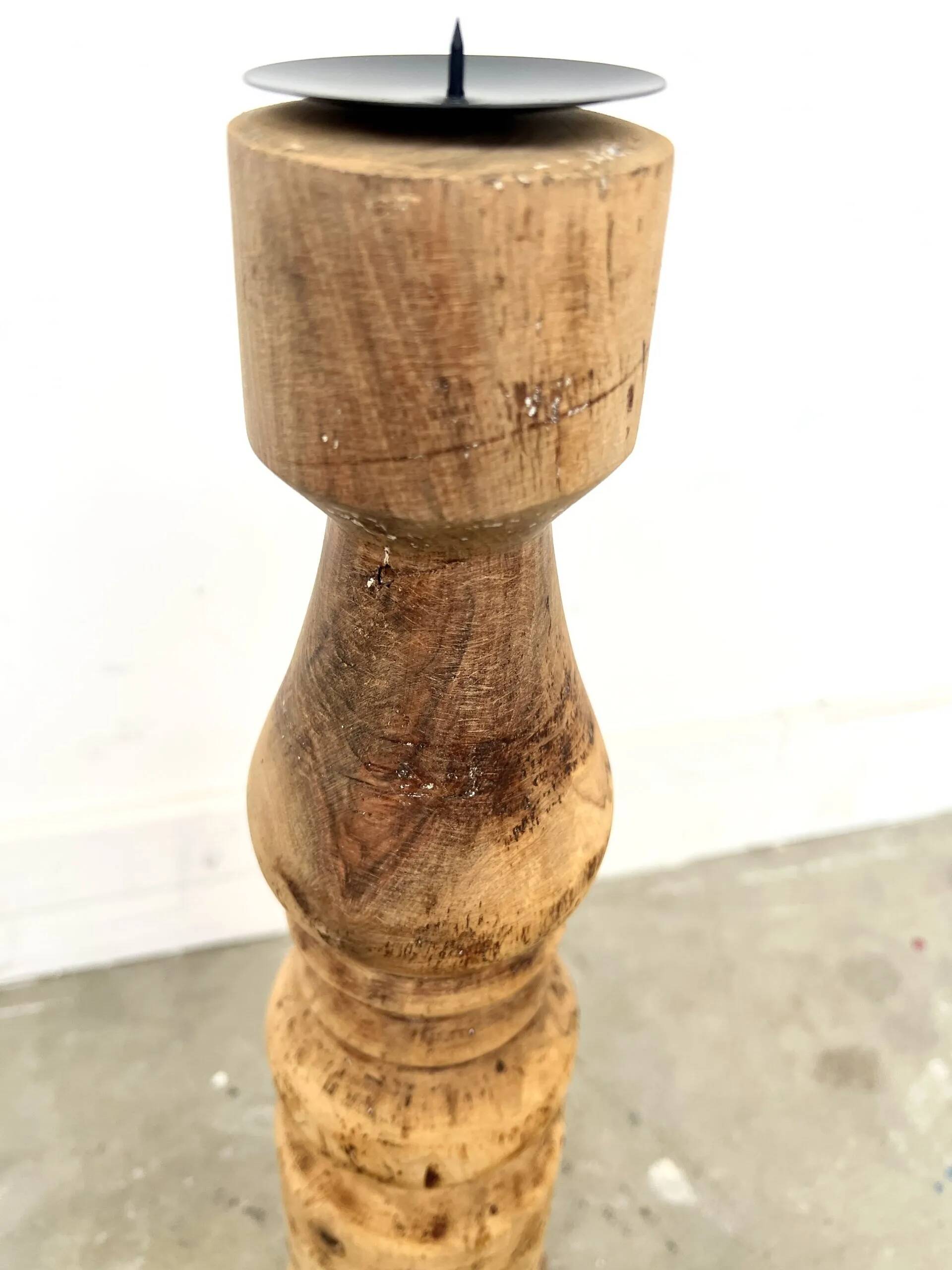 Pair of turned wooden candlesticks, raw and waxed.