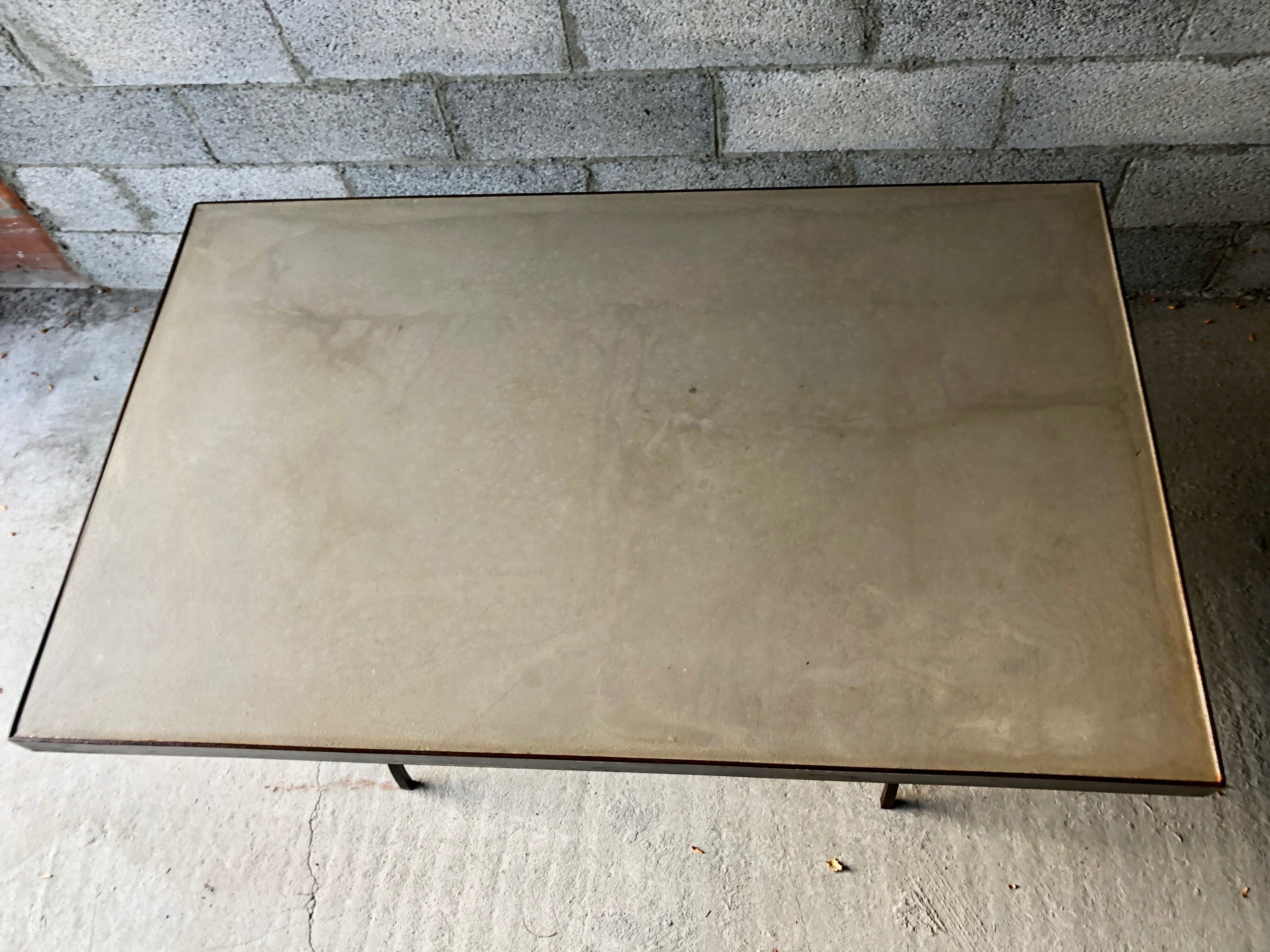 Table made of wrought iron and cement