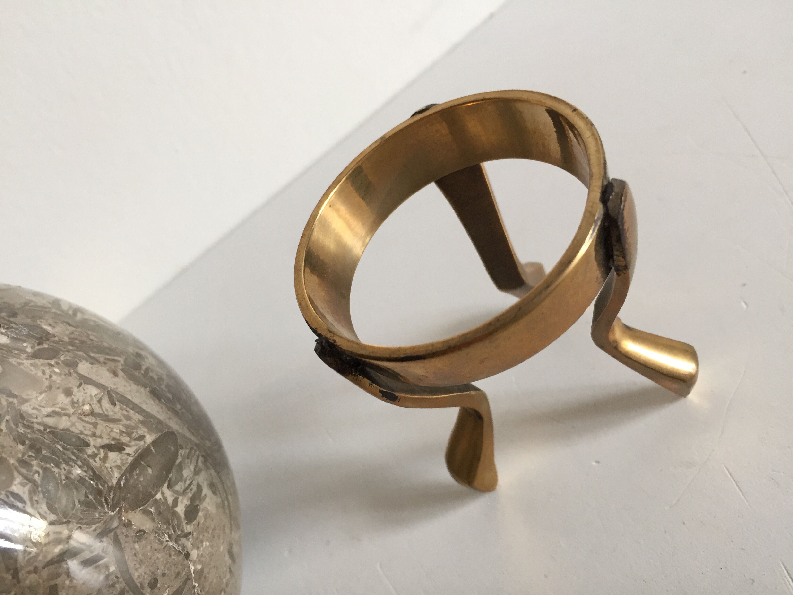 Marble ball paperweight on vintage brass