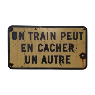 SNCF sign "One train can hide another"