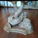 Glass table with carved wooden legs featuring intertwined fish.