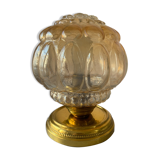 Old vintage table lamp made of amber molded glass