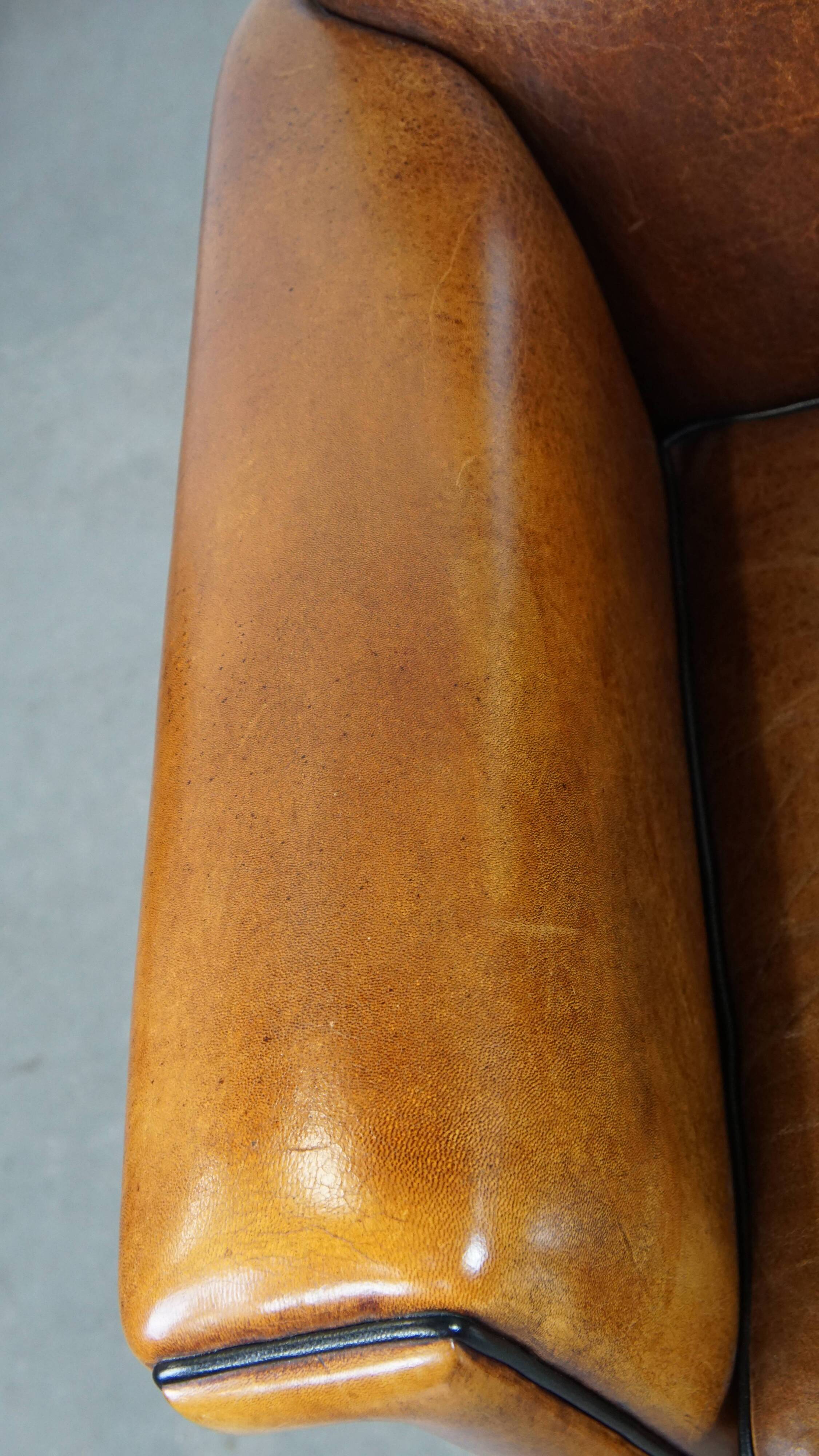 Sheep leather Art Deco design armchair finished with black piping