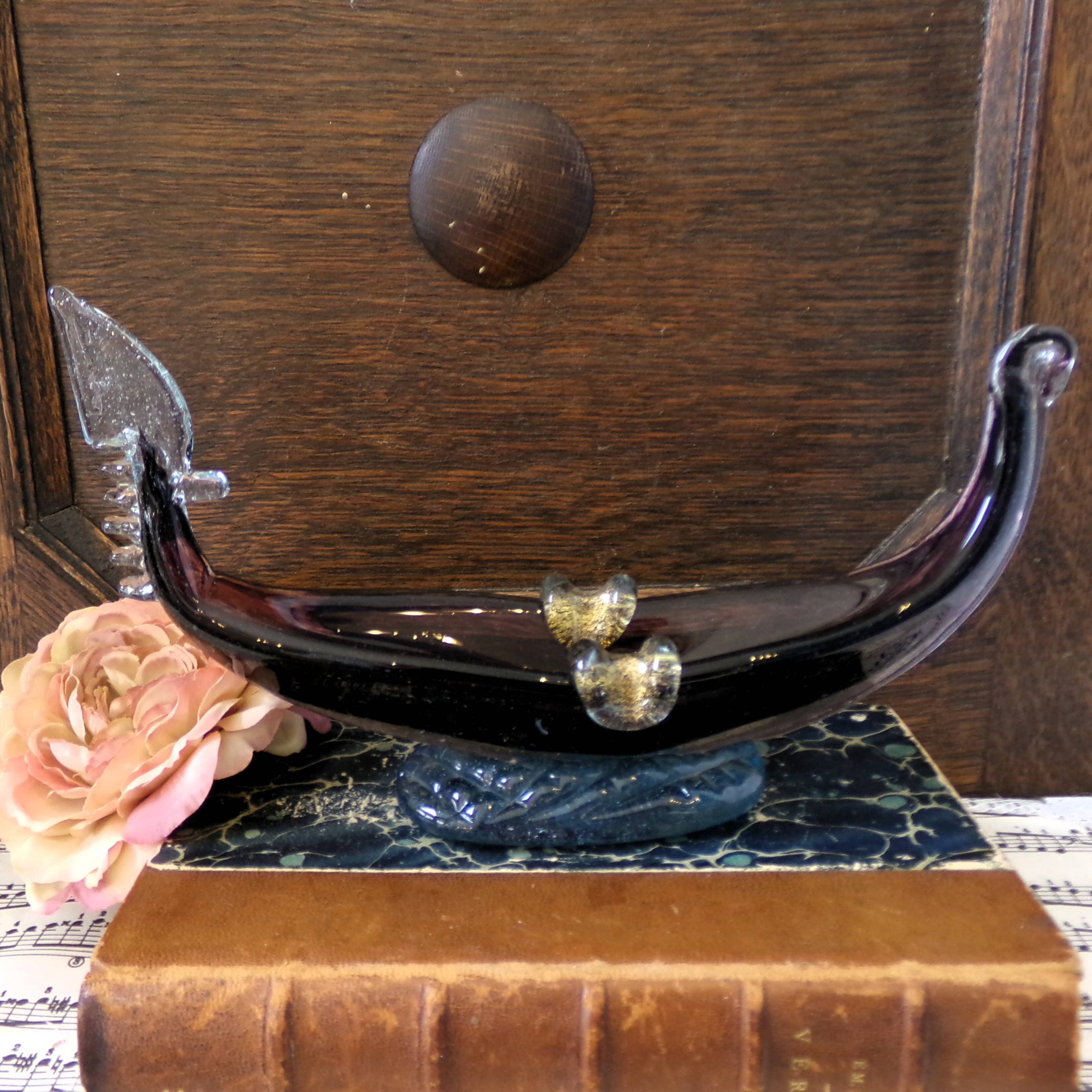 Murano glass gondola placed on a blue water-effect glass base