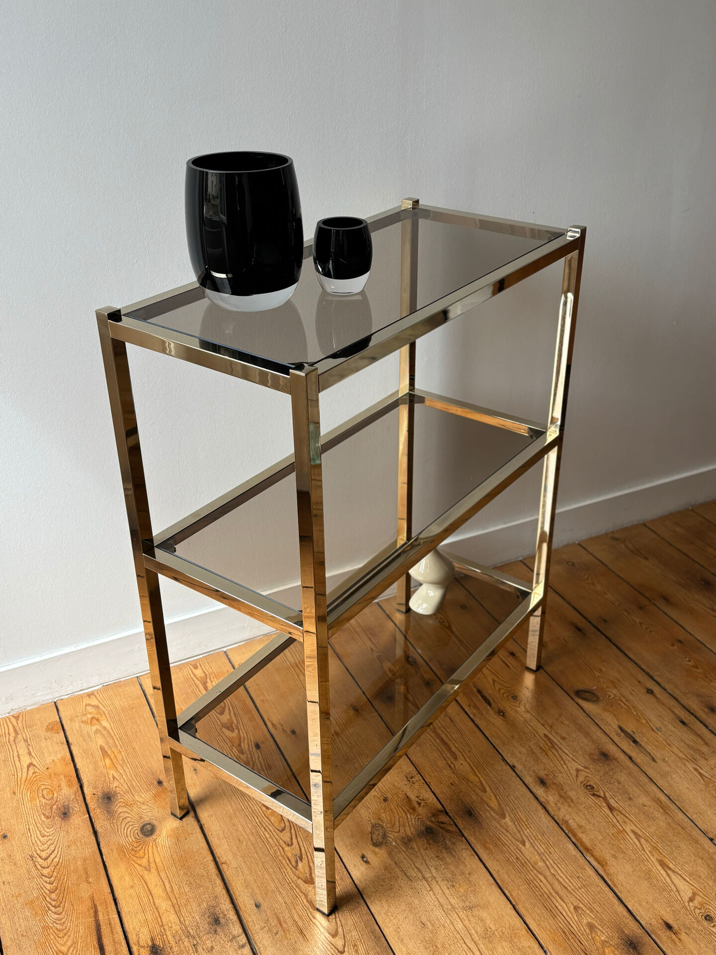 Brass and smoked glass library shelves