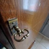 Vintage 1960s wooden wardrobe with a central mirror and tapered legs.