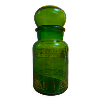 Green apothecary jar with golden patterns