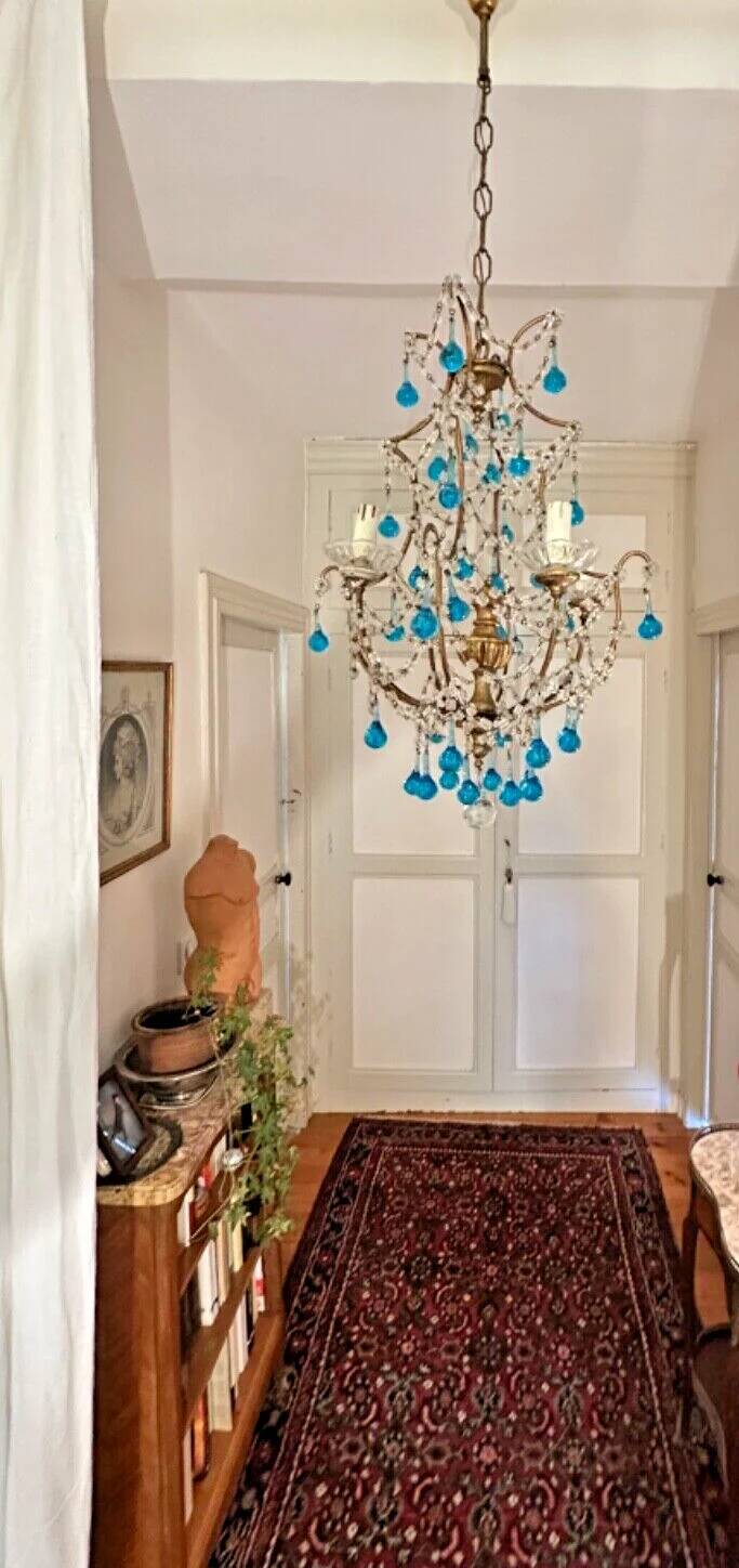 Italian chandelier with blue beads and gilded wood.