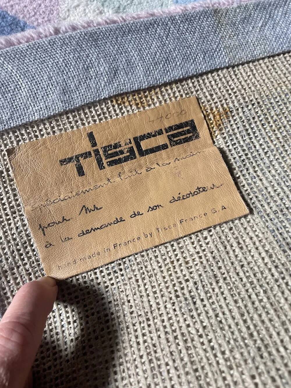 Hand-knotted wool rug by Tisca with a geometric pattern, signed "ILES", France, 1990s.