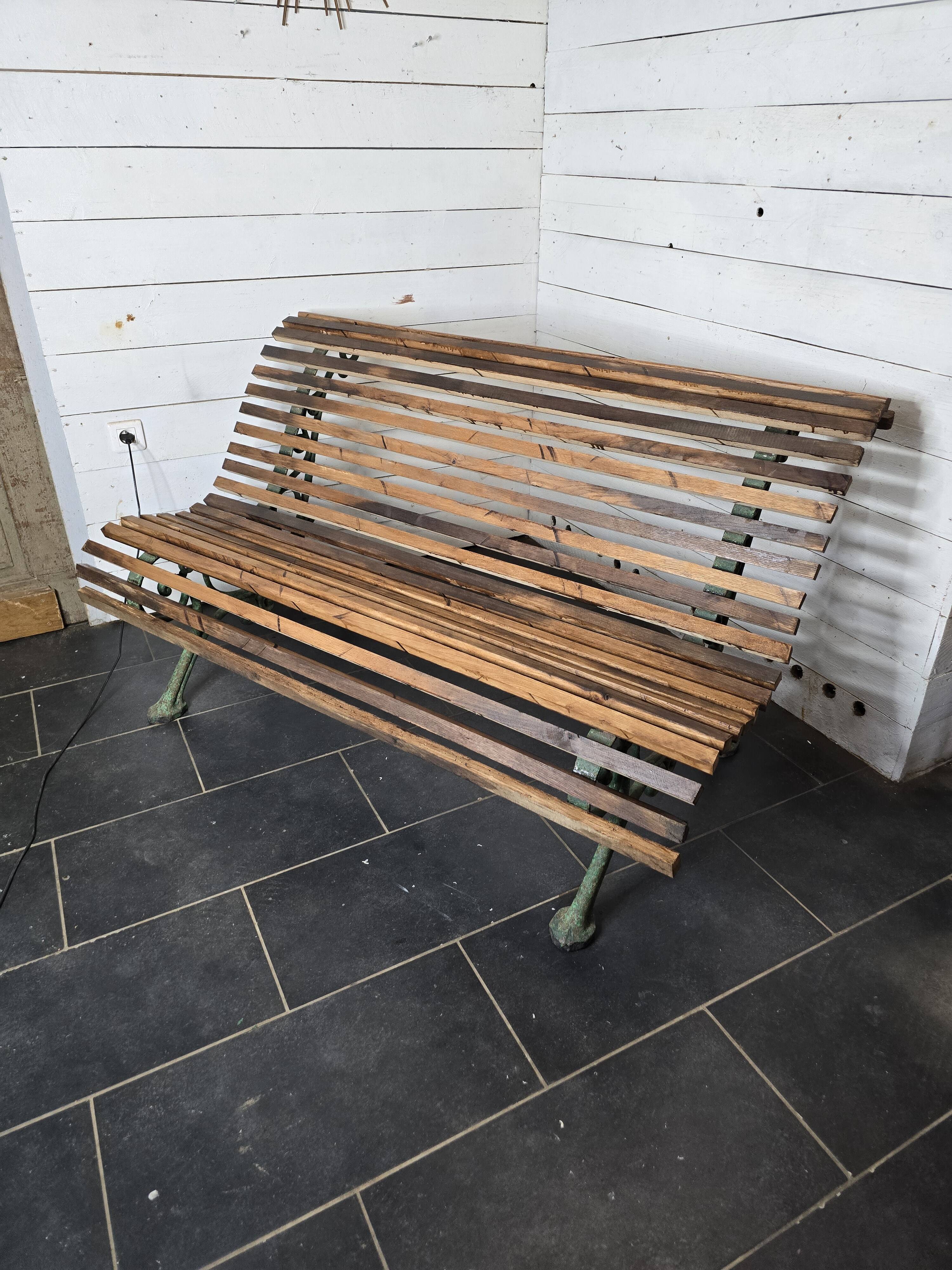 Old cast iron garden bench with oak slats