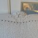 Louis XV style headboard with pearl grey patina, upholstered in off-white bouclette.