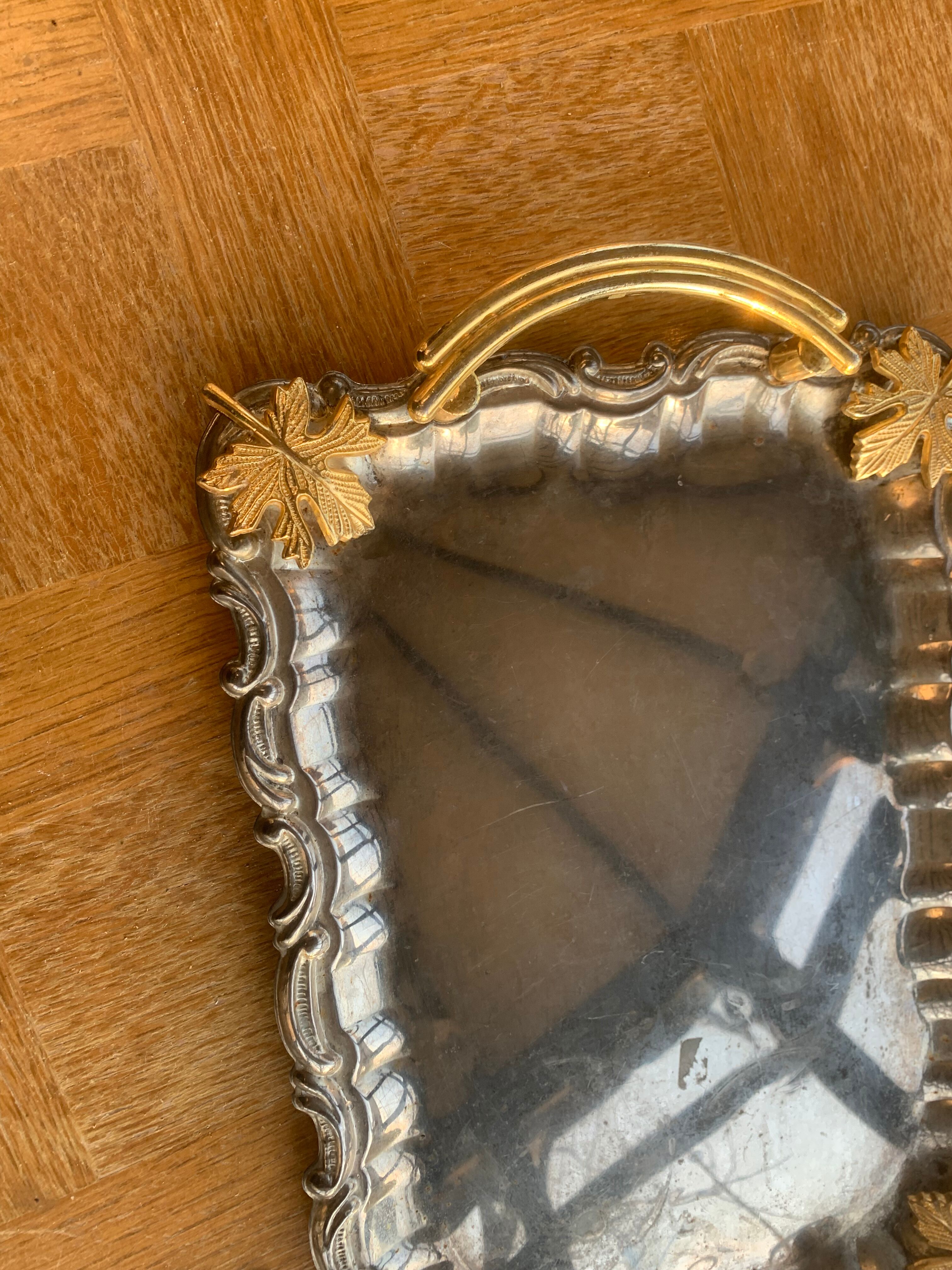 Silver metal top and decoration of foliage and handles in vintage brass