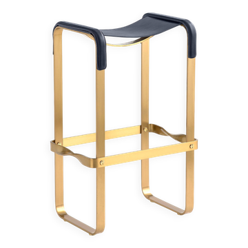 Contemporary classic bar stool in aged brass and navy blue leather.