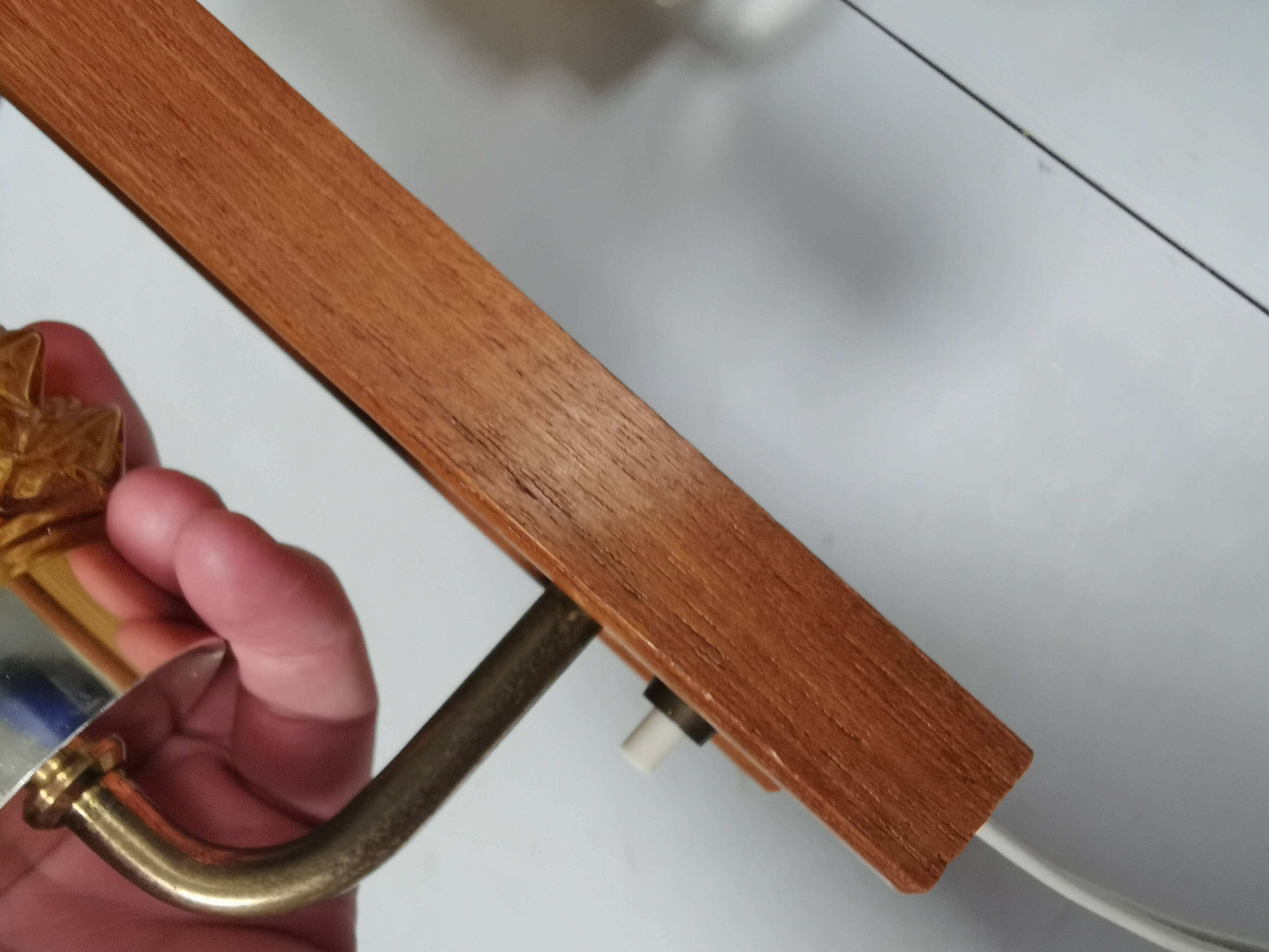 A set of wall lamps in teak wood, with amber colored glass