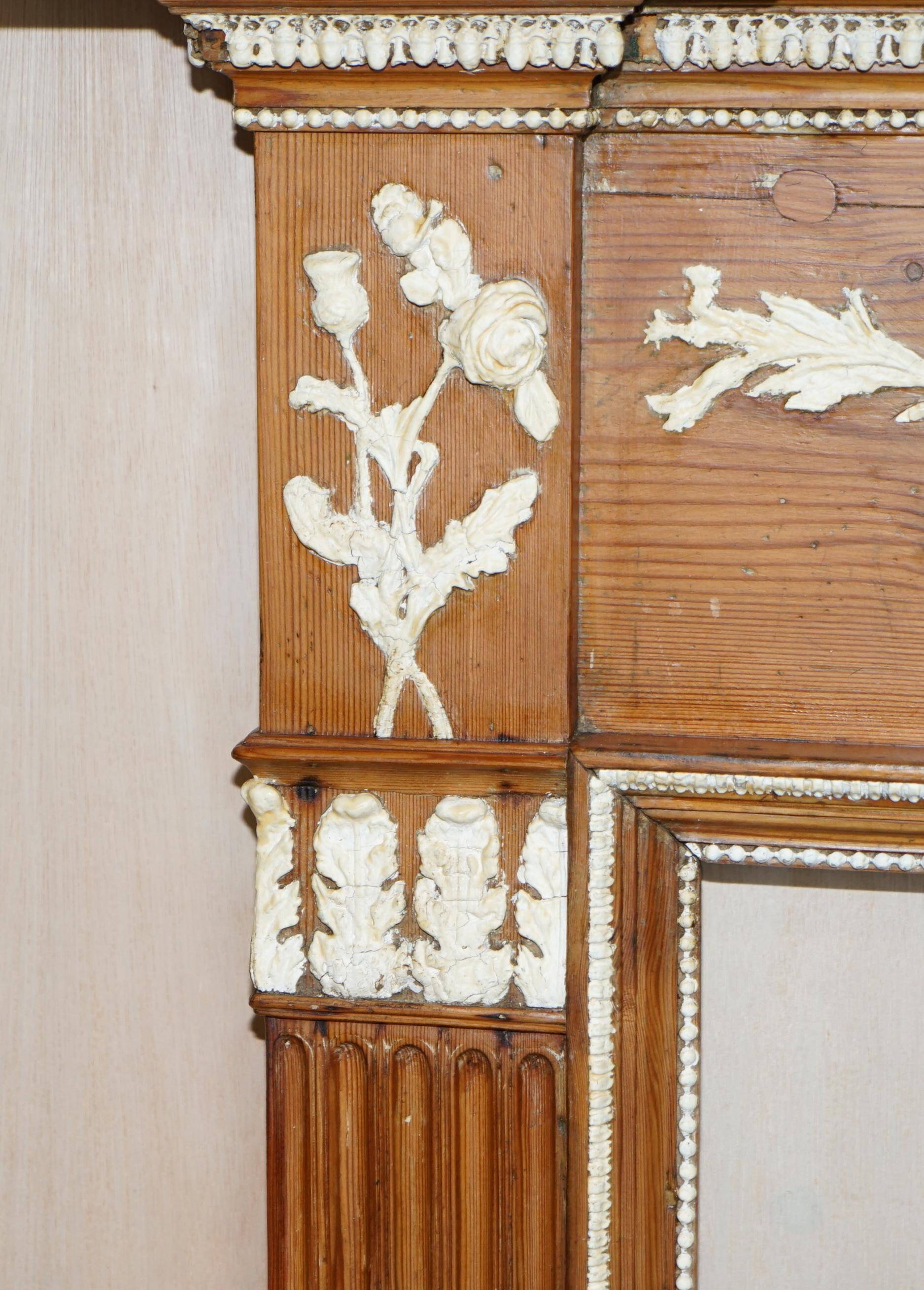 Victorian antique fireplace in tarred pine and sculpted gesso.