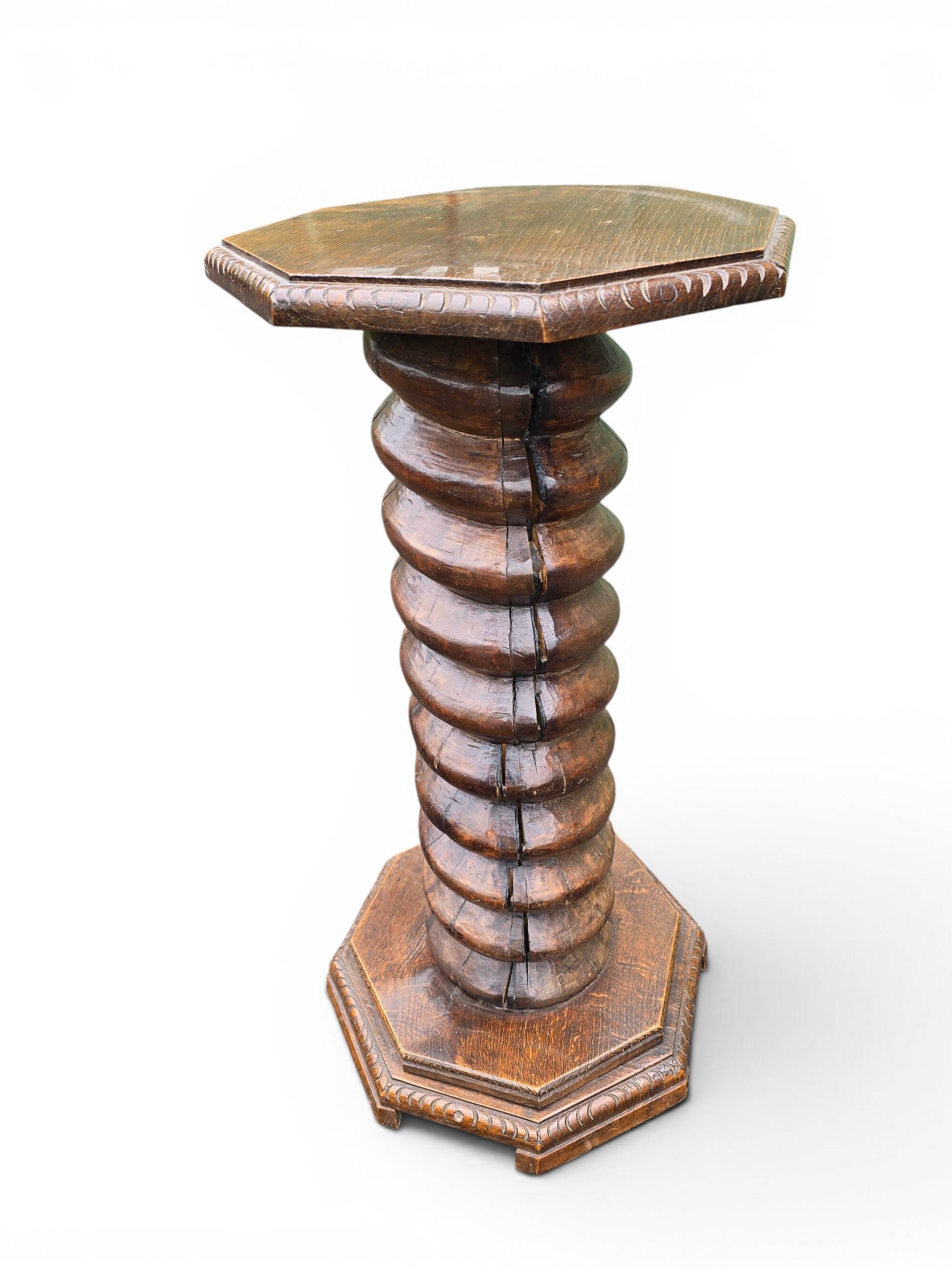 Antique carved solid oak pedestal, octagonal top and turned column.