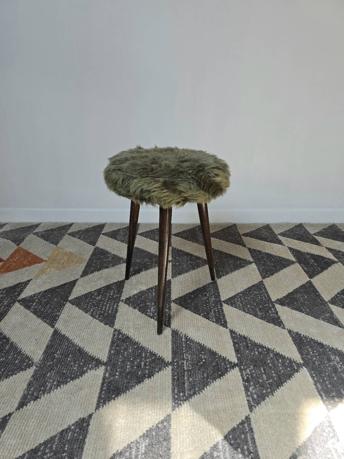 Green wooden tripod stool
