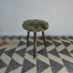 Green wooden tripod stool