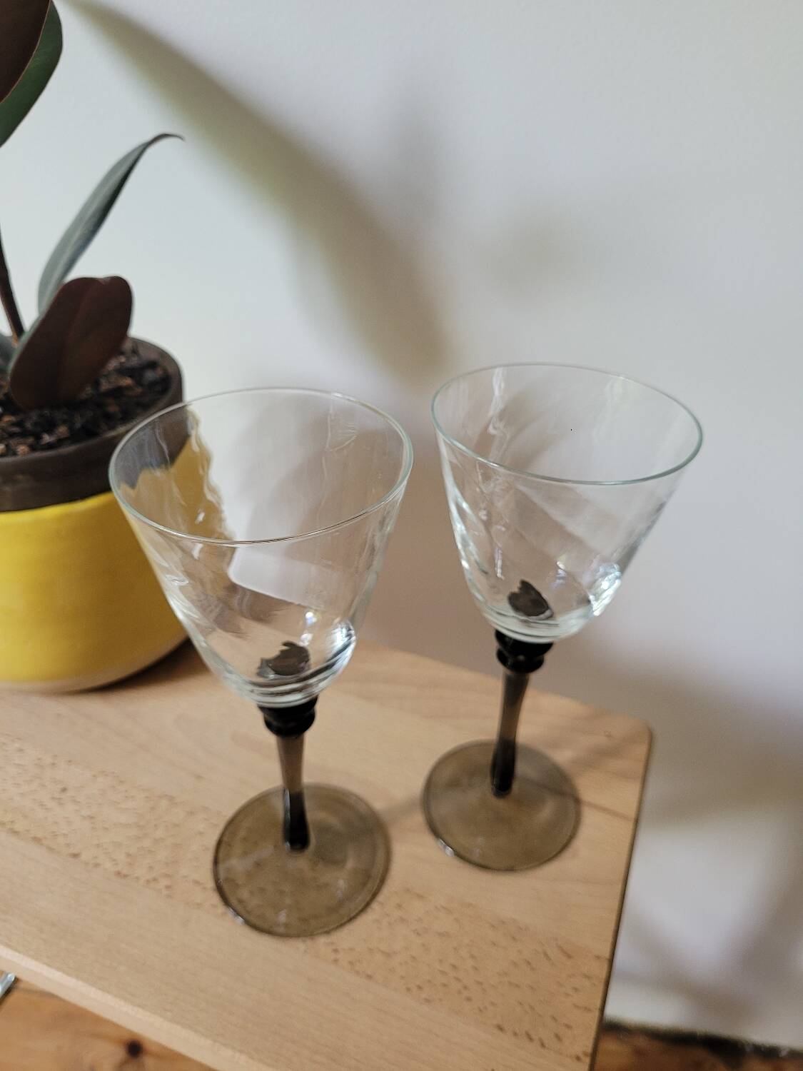 Two smoked black stem wine glasses