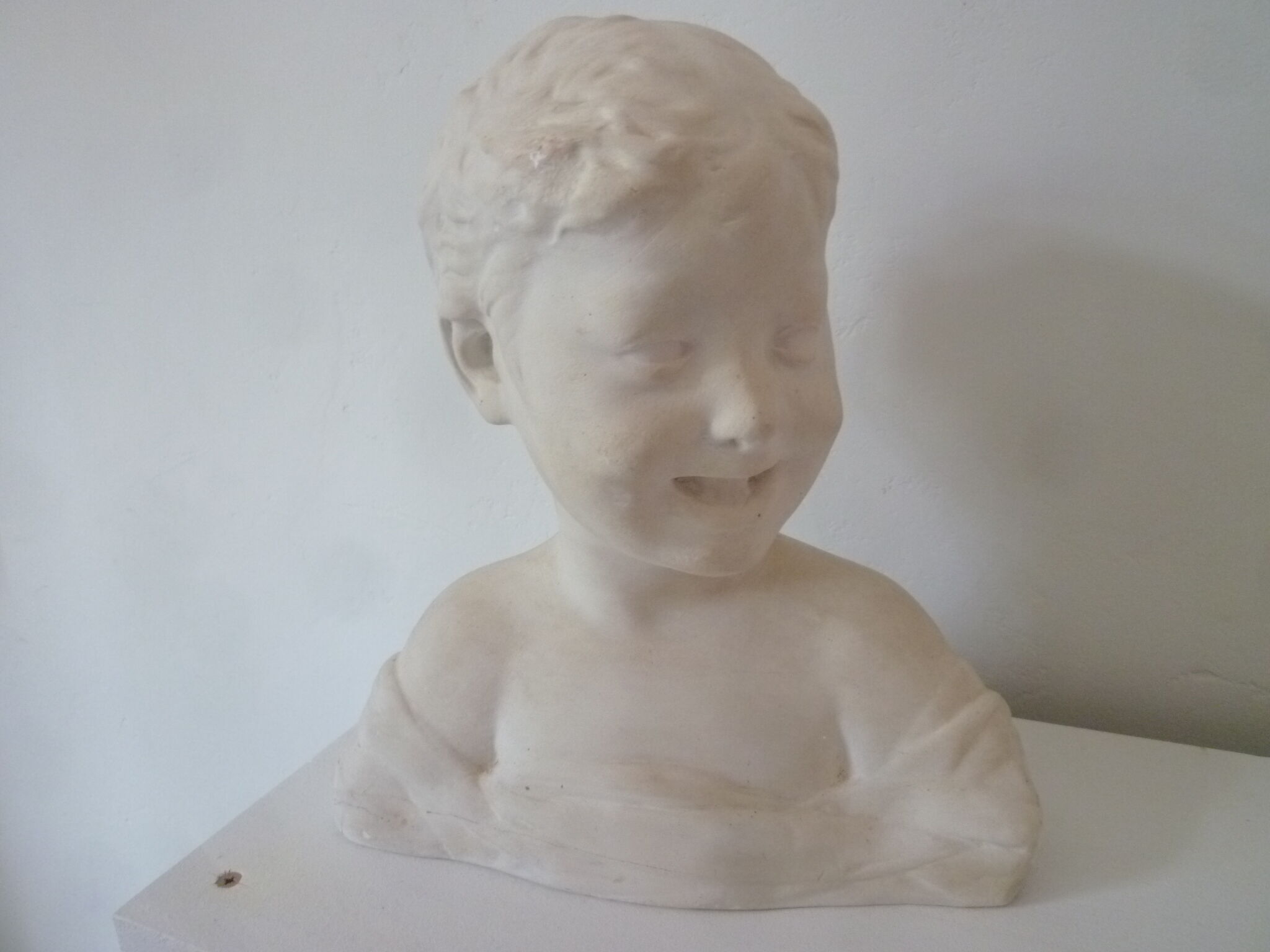 Bust young boy in plaster