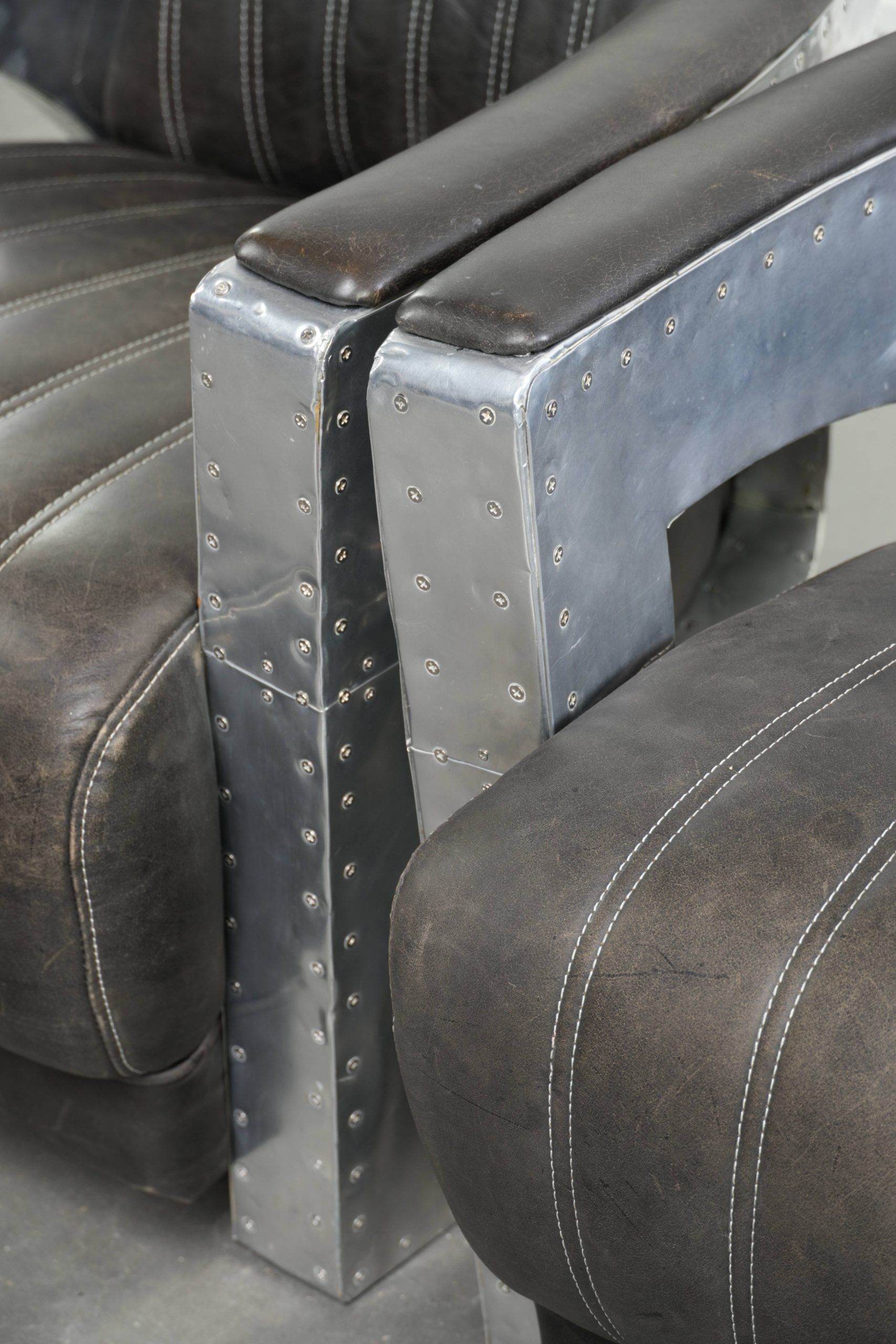 Set of 2 sturdy industrial black cowhide Aviator design armchairs with aluminium and rivets