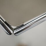 Living table. chrome metal, curved smoked glass slab, france, circa 1970.