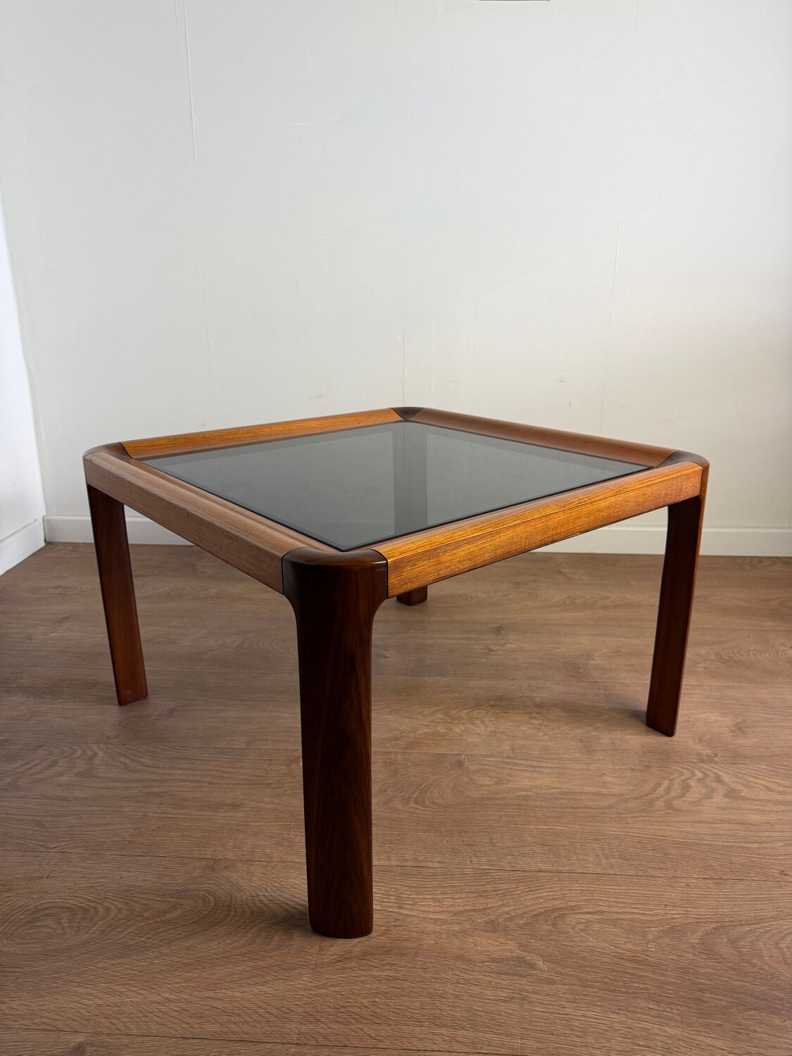 Square wooden coffee table with glass.