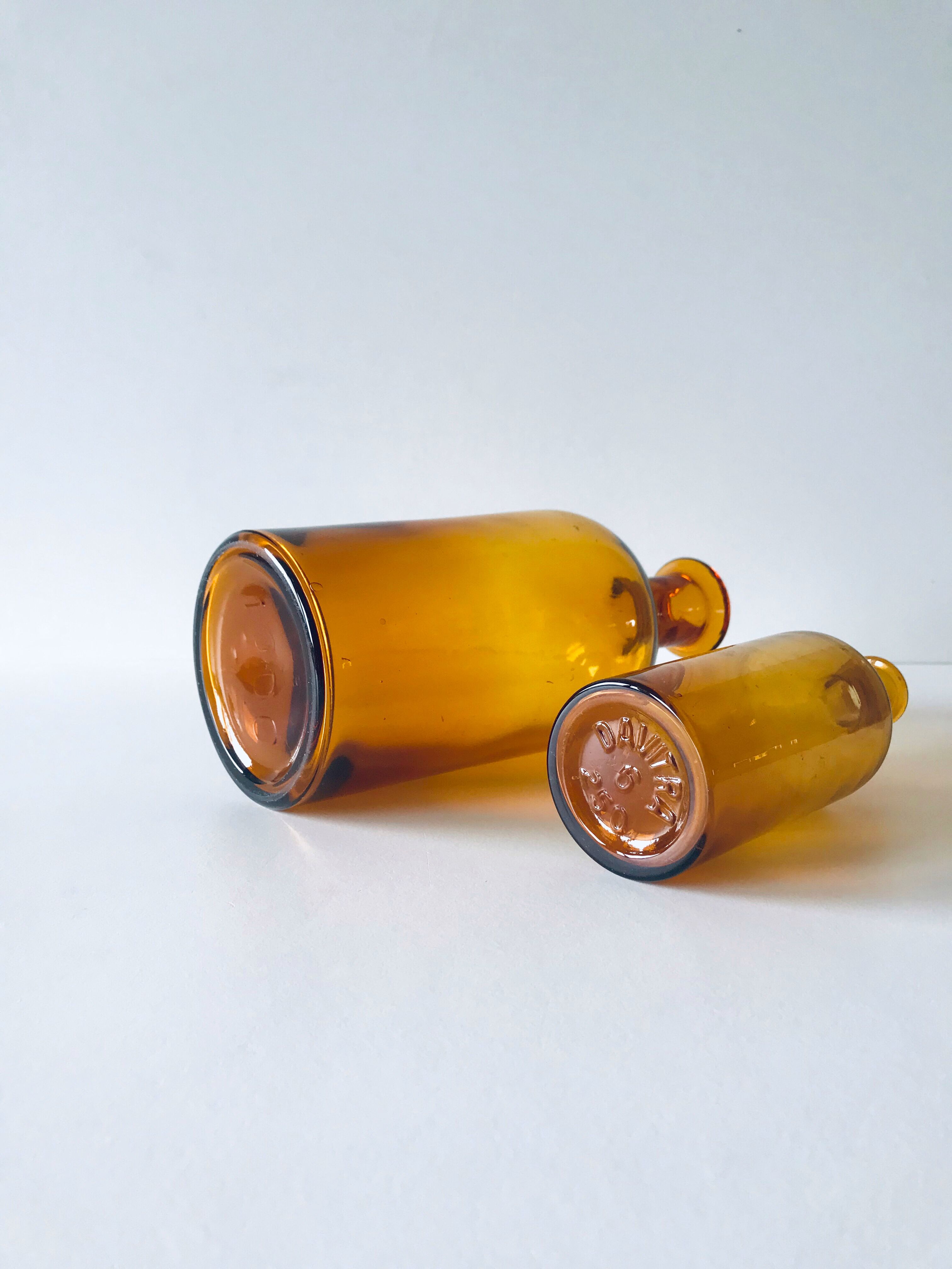Duo of ancient apothecary flakes in amber glass