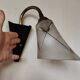 1950s wall lamp, metal, flexible brass stem and opaque shade.