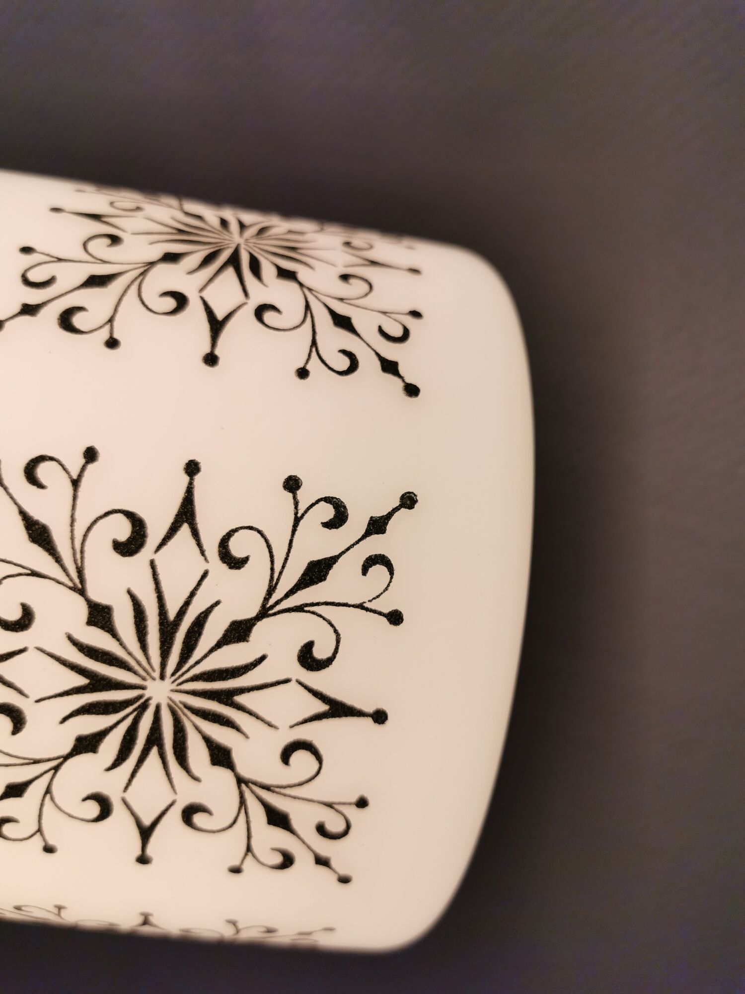 Scandinavian hanging lamp in white glass with inlayed black motifs.