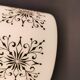 Scandinavian hanging lamp in white glass with inlayed black motifs.