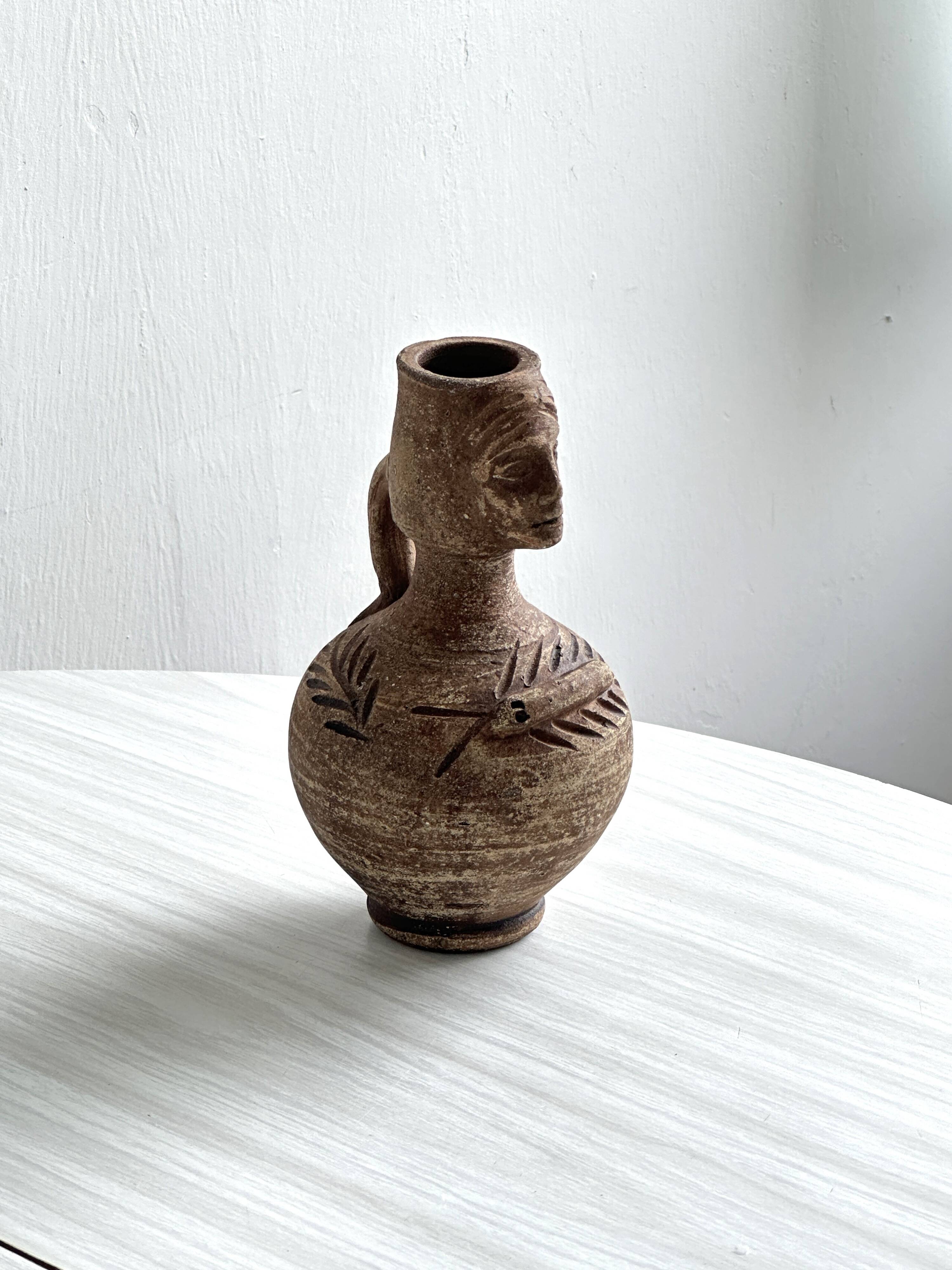 Ceramic woman face vase pitcher.