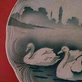 Plate of earthenware dabbling in swans