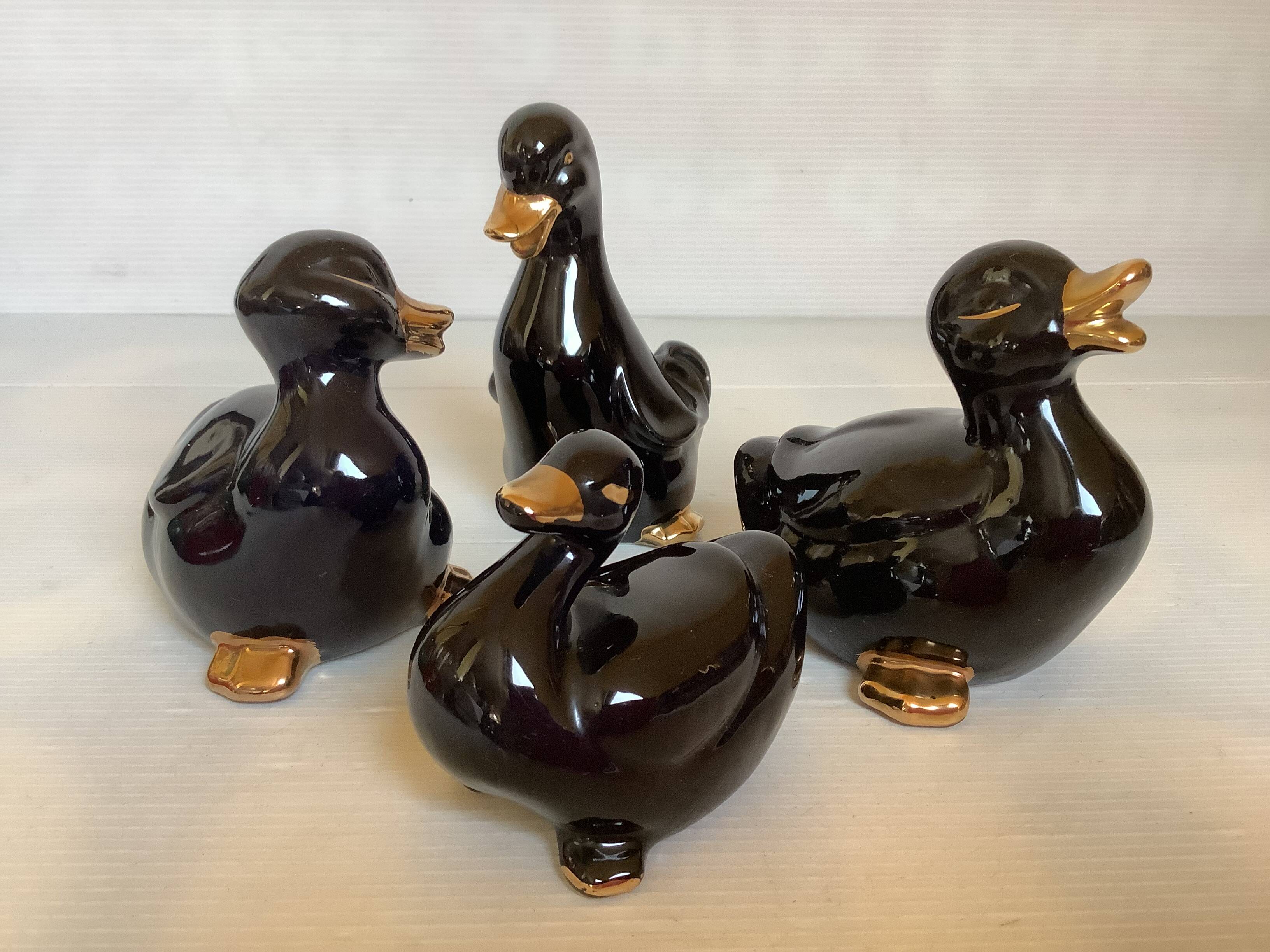 Four little black and golden ducks.
